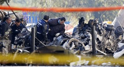 Forensics workers on Wednesday survey the scene of a plane crash in Mexico City that killed a top Mexican official.  (Associated Press / The Spokesman-Review)