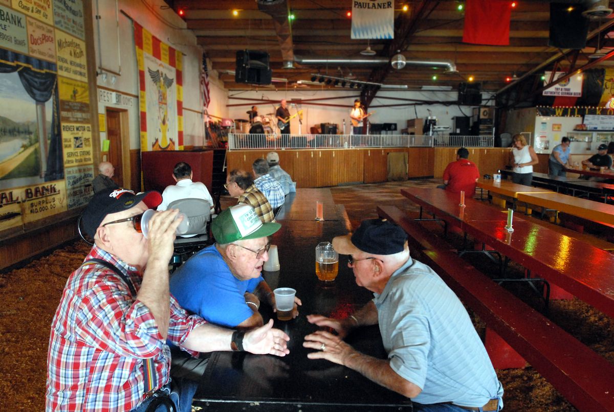 Bob Busherd, George Lawson and Jim Campbell, of Moses Lake, drink beers in the Bier Garten Friday, the first day of Deutschesfest. (Jesse Tinsley / The Spokesman-Review)