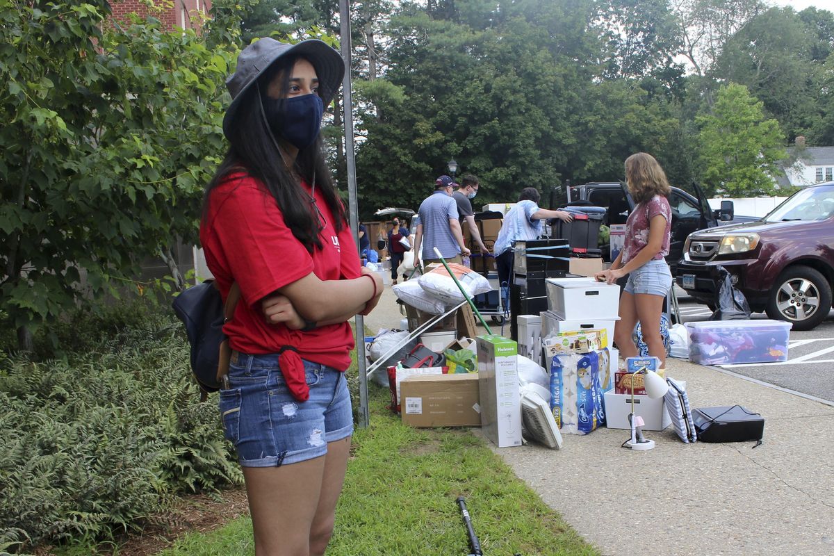 UConn sophomore Sahiti Bhyravavajhala assists students moving into Shippee Hall on the Storrs, Conn. campus, Friday, Aug. 27, 2021. UConn is one of many schools across the nation mandating that returning students be vaccinated against COVID-19. An analysis by The Associated Press shows 26 of the nation