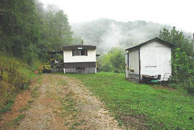 
Pictured on Tuesday is the mobile home, left, and tool shed in  Big Creek, W.Va., where authorities say 20-year-old  Megan Williams was  held captive for at least a week and tortured. Associated Press
 (Associated Press / The Spokesman-Review)