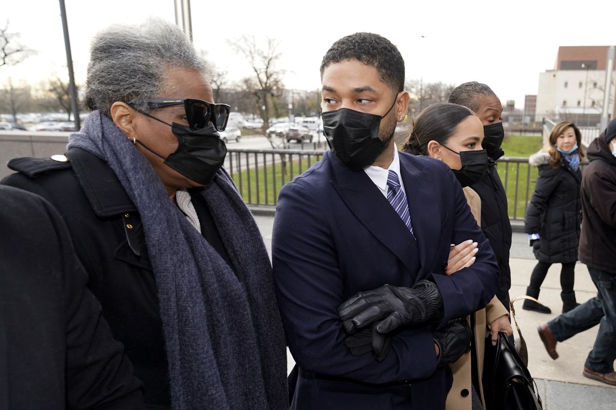 Actor Jussie Smollett looks back at his mother as they arrive with other family members Monday, Nov. 29, 2021, at the Leighton Criminal Courthouse for jury selection at his trial in Chicago. Smollett is accused of lying to police when he reported he was the victim of a racist, anti-gay attack in downtown Chicago nearly three years ago, in Chicago.  (Charles Rex Arbogast)