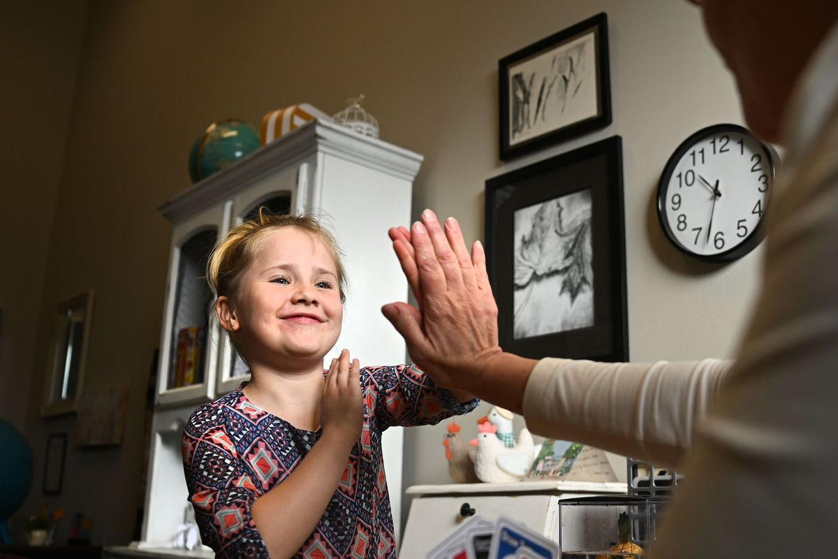 Seven-year-old Taylor Repp, who is diagnosed with dyslexia, gets a high-five from Michelle Gibson of the Inland Northwest Dyslexia Alliance during a reading intervention session at Northwest Christian Central Campus on Thursday, March 28, 2024.  (Kathy Plonka/The Spokesman-Review)