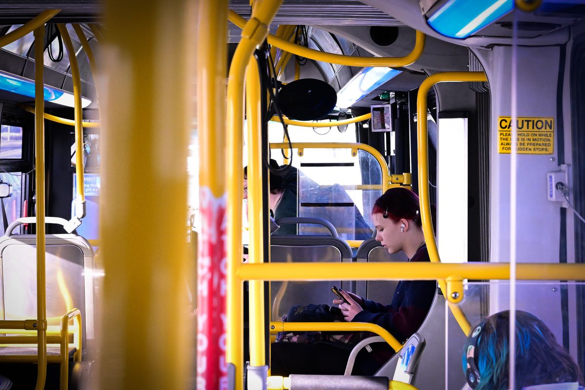Mia Steiner checks her phone as she rides an STA Bus on Thursday in Spokane.  (Tyler Tjomsland/The Spokesman-Review)