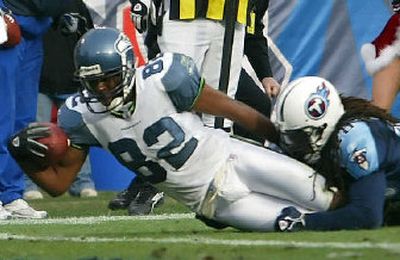 
Darrell Jackson stretches over the goal line to score the winning touchdown against Titans safety Lamont Thompson.
 (File/Associated Press / The Spokesman-Review)