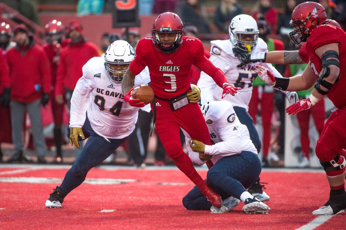 Eastern Washington quarterback Eric Barriere  is sacked by two  UC Davis players in an FCS quarterfinal last Saturday  at Roos Field in Cheney. (Libby Kamrowski / The Spokesman-Review)