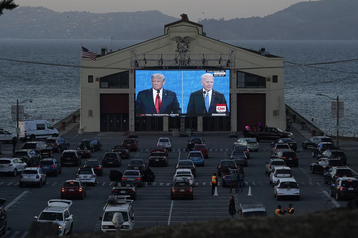People watch from their vehicles as President Donald Trump and the Democratic presidential nominee, former Vice President Joe Biden, speak Oct. 22 during a presidential debate watch party at the Fort Mason Center for Arts & Culture in San Francisco.  (Jeff Chiu)