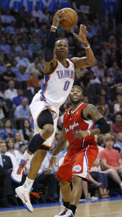 Thunder guard Russell Westbrook shoots in front of Mo Williams. (Associated Press)
