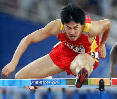 
China's Liu Xiang clears the final hurdle in the 110s on his way to gold.
 (Associated Press / The Spokesman-Review)