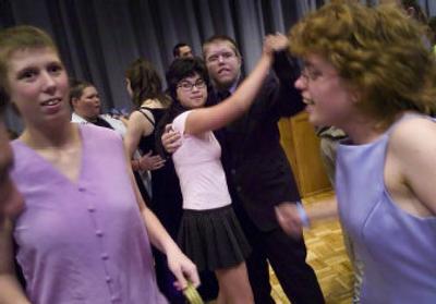 
Malia Boatman and Spenser  Martin, center, dance at the Spring Fling on  Monday  at Northern Quest Casino in Airway Heights. 
 (Colin Mulvany / The Spokesman-Review)