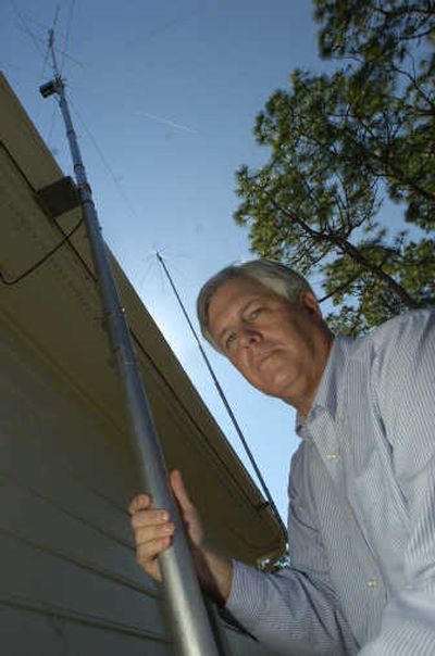 Amateur radio operator Paul Magnabosco poses with a pair of antennas on the roof of his Wilmington, N.C., home last spring. He lives in a neighborhood without Covenants, Conditions and Restrictions (CC&R's), common in homeowners associations, so there was no rule to stop him from mounting the antenna on his home.
 (AP / The Spokesman-Review)