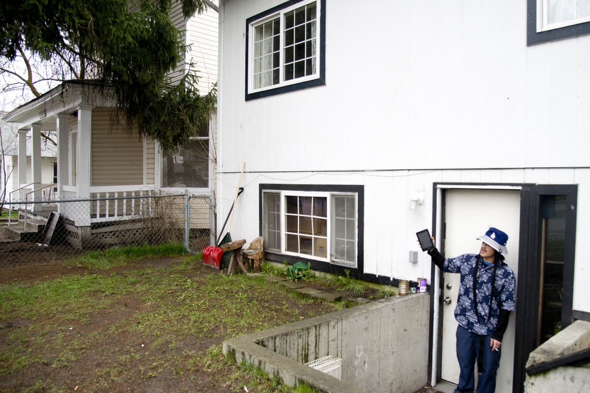 J.J. Kemple stands outside his apartment on Diamond Avenue in Hillyard on Wednesday. He said the house at left, where a woman was found wounded Tuesday morning and later died, was referred to by neighbors as a drug users hangout, with visitors coming and going at all hours. (Jesse Tinsley)