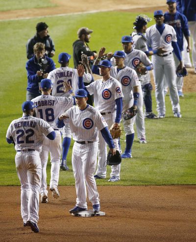 Chicago Cubs players celebrate after Game 2 of the National League Division Series against the San Francisco Giants, Saturday, Oct. 8, 2016, in Chicago. The Cubs won 5-2. (Associated Press)