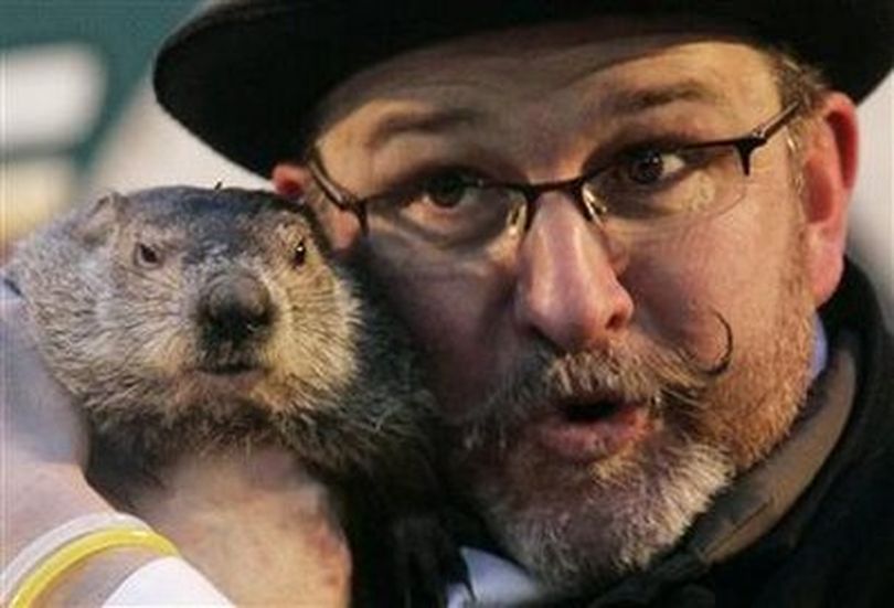 Famed weather prognosticating groundhog Punxsutawney Phil makes his annual prediction while being held by Co-Handler Ben Hughes on Gobbler's Knob in Punxsutawney, Pennsylvania, on the 124th Groundhog Day, February 2, 2010. Phil saw his shadow, predicting six more weeks of winter.
REUTERS/Jason Cohn
Photo Tools
 (Jason Cohn / X01062)