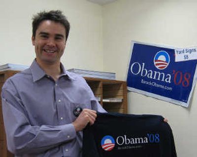 
Joey Bristol, Idaho field director for Obama, shows off some  campaign gear at the Obama headquarters in Boise. 
 (Betsy Russell / The Spokesman-Review)
