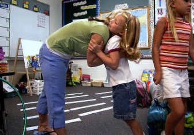 
Monica Howard, 7, gives her mom, Lisa, a hug goodbye in Dawn Brand's first- and second-grade class on the first day of school at Skyview CCS Elementary. 
 (Liz Kishimoto / The Spokesman-Review)