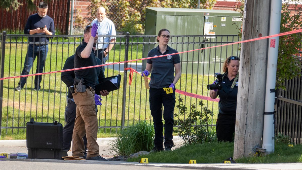 Law enforcement personnel investigate the scene of a confrontation between Spokane Police and a man with a gun somewhere near Fifth Avenue and the area between Browne and Division streets early Wednesday.  (Jesse Tinsley/The Spokesman-Review)