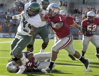 Oregon running back Jeremiah Johnson plows past Washington State’s Myron Beck, on ground, and Alfonso Jackson.  (Christopher Anderson / The Spokesman-Review)