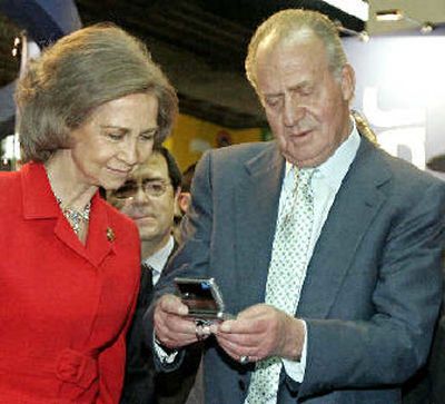 
Spain's King Juan Carlos and Queen Sofia look at a new mobile phone on the first day of the 3GSM World Congress in Barcelona, Spain, on Monday.
 (Associated Press / The Spokesman-Review)