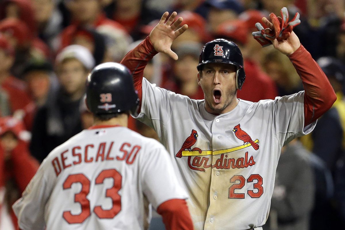 St. Louis Cardinals’ David Freese, right, reacts as he and Daniel Descalso scored the go-ahead runs in the ninth inning of Friday’s game. (Associated Press)