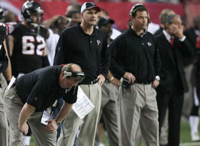 
Atlanta coaches, including head man Jim Mora Jr., second from right, are working under the scrutiny of owner Arthur Blank, right. 
 (Associated Press / The Spokesman-Review)