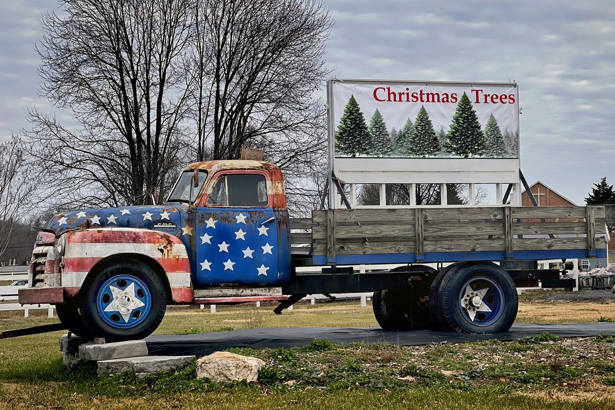 A vintage truck holds a sign featuring picturesque Christmas trees at Grey Goose Farm in Germantown, Md., on Thursday.  (Michael S. Williamson/The Washington Post)