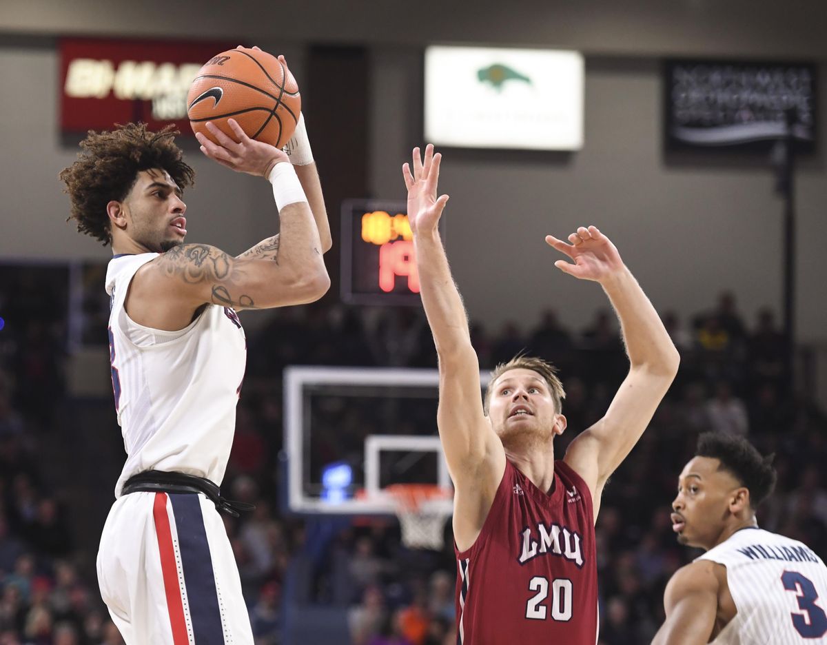 Gonzaga guard Josh Perkins nails a 3-point shot over Loyola Marymount guard Erik Johansson (20), Thursday, Feb. 15, 2018, in the McCarthey Athletic Center. (Dan Pelle / The Spokesman-Review)