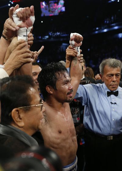 WBO welterweight champion Manny Pacquiao celebrates after defeating Chris Algieri by decision. (Associated Press)