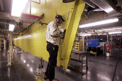 
A Boeing employee works on a wing assembly of a Boeing 777 at the company's plant in Everett.
 (The Spokesman-Review)