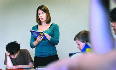 
Ferris High School teacher Emily Torres, seen here reading to her class in May, is seeking national board certification in order to qualify for salary increases authorized by the state Legislature. 
 (Brian Plonka / The Spokesman-Review)