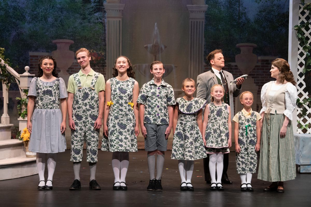The VonTrapp children, from left, Liesl, Friedrich, Louisa, Kurt, Brigitta, Marta and Gretl assemble with their father Georg Von Trapp and their governess Maria in a scene from Spokane Valley Summer Theatre’s “The Sound of Music,” which opens Friday at University High School. Captain Von Trapp, behind the children, is played by Michael Muzatko and Maria is played by Jennifer Tindall, right. The children are played by, left to right, Maddie Burgess, Kyle Adams, Noelle Fries, Caden Adams, Alex Read, Mackenzie Kelly and Pearl Wollenhaupt. (Jesse Tinsley / The Spokesman-Review)