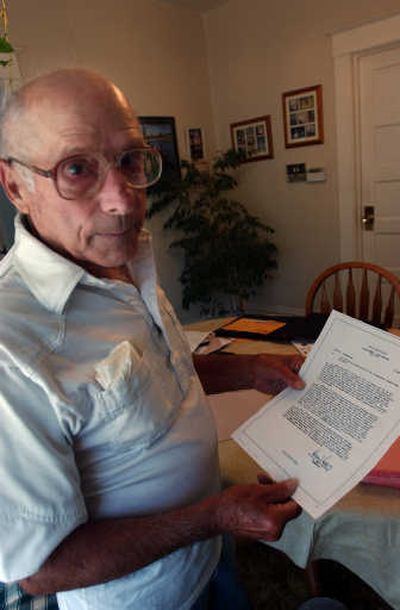 
Gene Scolavino shows the 1945 letter describing his honorable service in World War II. 
 (KATE CLARK / The Spokesman-Review)