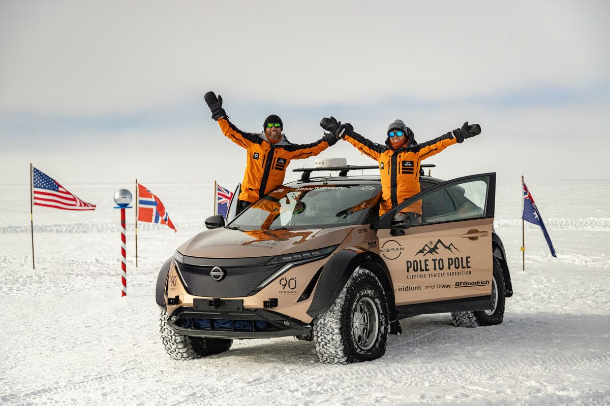 Chris and Julie Ramsey at the South Pole with the modified Nissan Ariya SUV they drove across North and South America to Antarctica.  (Chris Ramsey/null)