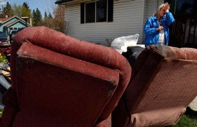 
Ruby Stoker, owner of Garden Homes, wipes soot from her face while trying to salvage a few items from the fire-damaged assisted-living center on Monday. 
 (Kathy Plonka / The Spokesman-Review)