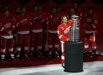 Red Wings captain Nicklas Lidstrom holds the Stanley Cup trophy during the team’s banner-raising ceremony before its opener against Toronto.  (Associated Press / The Spokesman-Review)