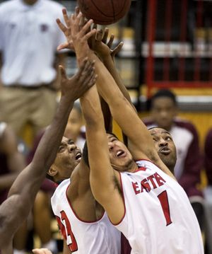 Eastern Washington Eagles Kyle Reid (23) and Eastern Washington Eagles guard Tyler Harvey (1) get their fingertips on a rebound in the first half of an NCAA college men's basketball game, Friday, Nov. 14, 2014, in Cheney, Wash. COLIN MULVANY colinm@spokesman.com ORG XMIT: WASPO (Colin Mulvany / The Spokesman-Review)