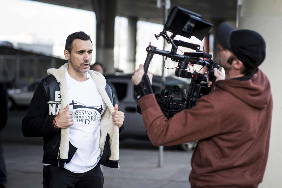 Live Life Forward TV Show host Adrian Paul films an introduction to the “No Poverty / Zero Hunger” episode featuring Blessings Under the Bridge, an organization that serves dinner to the homeless under the freeway overpass at 4th Avenue  and McClellan Street. The show will air May 30 on Lifetime Television. (Colin Mulvany / The Spokesman-Review)