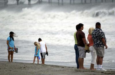 
Beachgoers look at the churning surf at Atlantic Beach, N.C., Saturday. A hurricane watch was posted for the Southeast coast as Ophelia strengthened into a hurricane once again.
 (Associated Press / The Spokesman-Review)