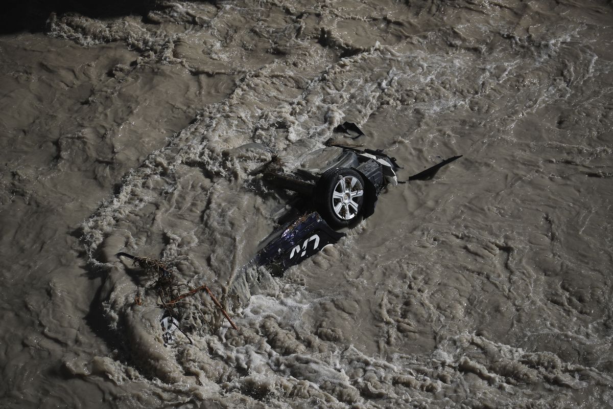 A car was swept away during floods in the Roya river of Breil-sur-Roya, near the border with Italy, Monday, Oct.5, 2020. Flooding has devastated mountainous areas in France