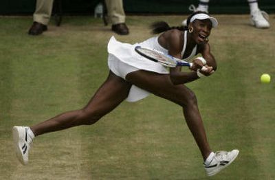 
Venus Williams returns a shot on her way to defeating France's Mary Pierce in their quarterfinal match on Centre Court. 
 (Associated Press / The Spokesman-Review)