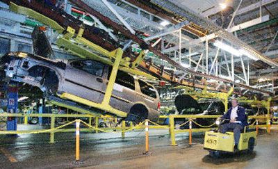 
A General Motors employee rides past the assembly line at the GM Assembly Plant in Doraville, Ga. GM announced Friday that it may form an alliance with Renault SA and Nissan Motor Co.
 (Associated Press / The Spokesman-Review)