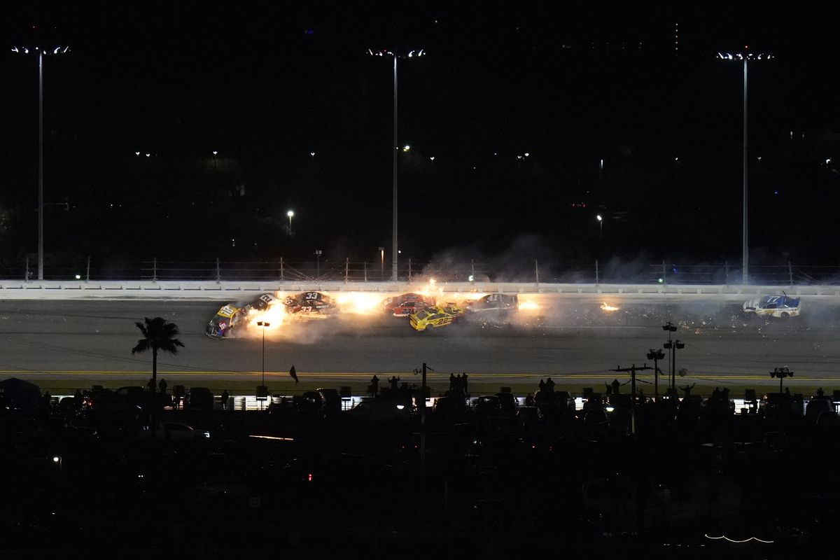 Racers crash during the last lap in the NASCAR Daytona 500 auto race at Daytona International Speedway, Monday, Feb. 15, 2021, in Daytona Beach, Fla. Among the driver involved were Kyle Busch (18); Brad Keselowski (2), who was in second before the crash; Joey Logano (22), who was leading; and Bubba Wallace (23).  (Chris O