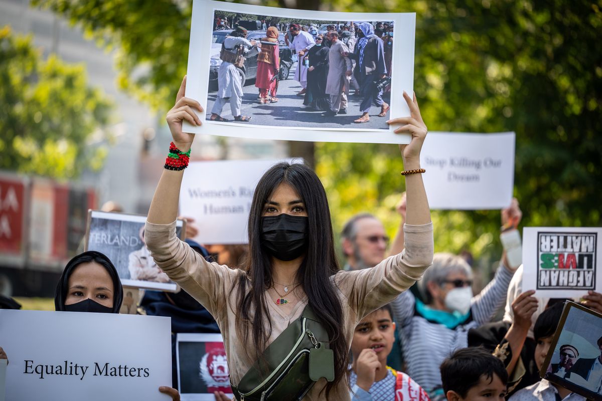 Mariam Amiri joins about 100 other people from the local Afghan community Wednesday in Riverfront Park to protest the takeover of Afghanistan by the Taliban.  (COLIN MULVANY/THE SPOKESMAN-REVI)