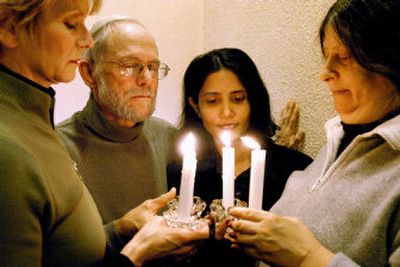 
Christian Peacemaker Teams members, from left, Jill Pritchard-Scott,  the Rev. Bob Holmes, Arunthathy Ratnasingham and Lyn Adamson, hold candles during a vigil in Toronto on Saturday. Four members of the group are  hostages in Iraq. 
 (Canadian Press / The Spokesman-Review)