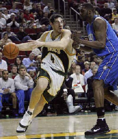 
Nick Collison of the SuperSonics, left, drives on Orlando Magic's Kelvin Cato during the second half Friday. 
 (Associated Press / The Spokesman-Review)
