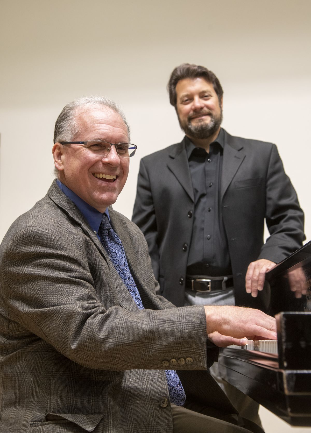 Whitworth professors Brent Edstrom, seated, and Philip Baldwin are both involved with the Peter Rivera and orchestra concert Friday. Edstrom charted a couple of song arrangements and Philip Baldwin will conduct the orchestra.  (Jesse Tinsley/THE SPOKESMAN-REVIEW)