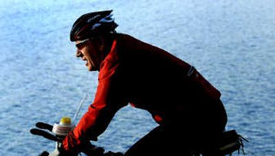 
John Stone cycles along the Centennial Trail in Coeur d'Alene early Thursday, preparing for today's Ironman competition. 
 (Kathy Plonka / The Spokesman-Review)