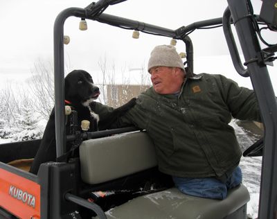 Craig Thomas takes a break from plowing a neighbor’s driveway in January 2008 to share a moment with his dog, Sport.
