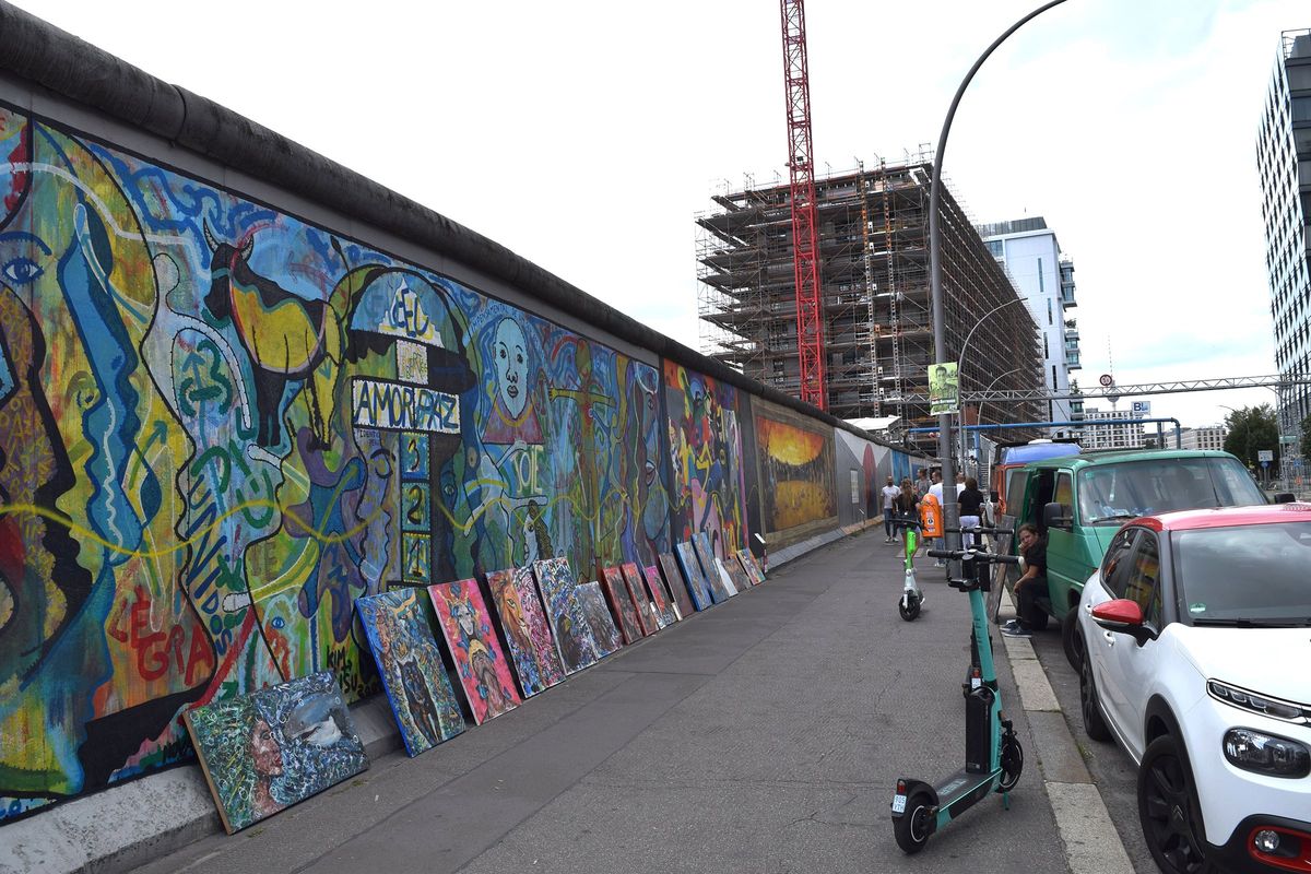 A high-rise construction project looming over the East Side Gallery, an open-air art exhibit created from the Wall’s longest intact stretch, highlights, to some, the relentless takeover of Berlin by global capitalism.  (Gabriel Popkin/For the Washington Post)