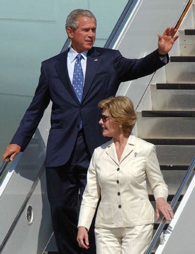 
President Bush waves as he leaves Air Force One with his wife, Laura, after returning to Central Texas Tuesday. They had attended ceremonies in Coronado, Calif., to mark the anniversary of the end of World War II. Bush plans to return to Washington today.
 (Associated Press / The Spokesman-Review)