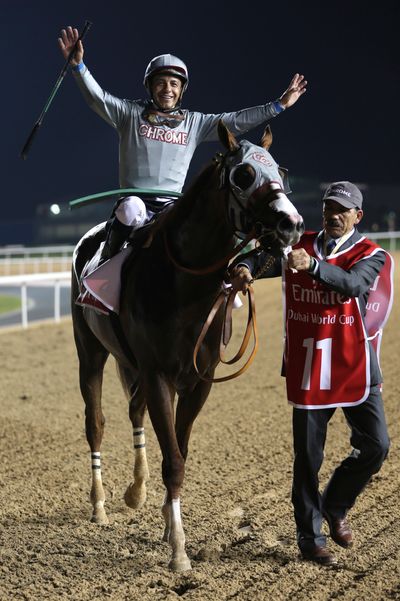 California Chrome jockey Victor Espinoza  celebrates after winning the Dubai World Cup. (Kamran Jebreili / Associated Press)